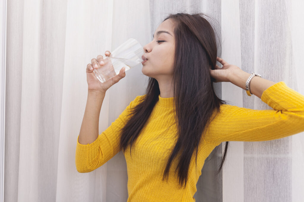 girl-drinking-water-touching-her-hair